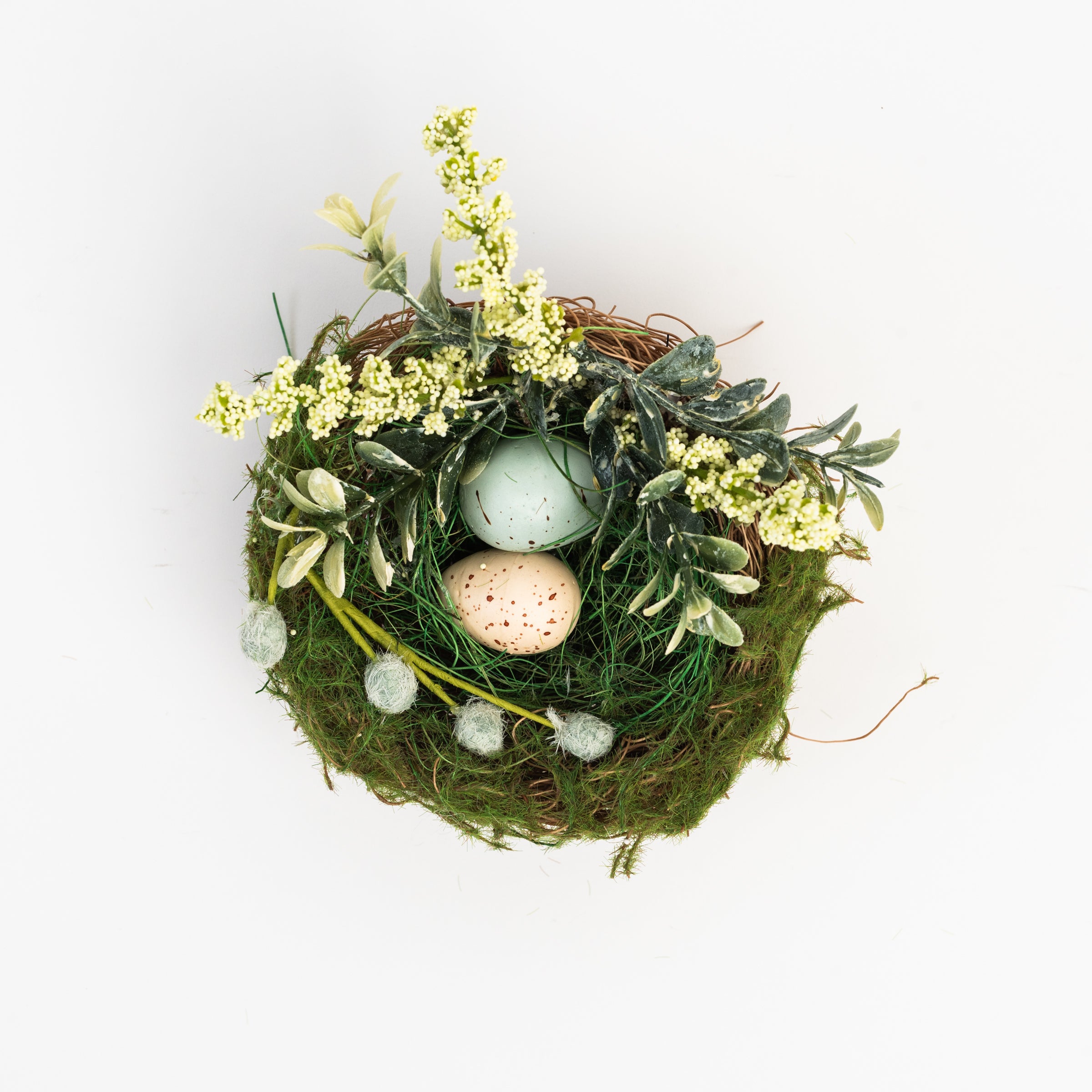 Easter Nest with Eggs and Faux Flowers on a white background at Addison West