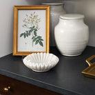 Mariella Marble Fluted Dish on a dark marble table at Addison West