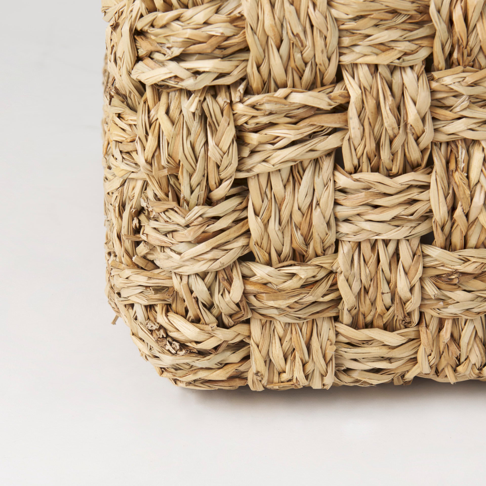 Adele 17.7L x 17.7W x 17.7H Medium Brown Seagrass Woven Square Pouf on a white background