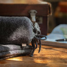 Charcoal grey Alpaca Travel Wrap on a wood desk