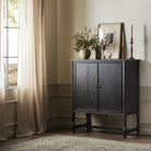 Amber Lewis x Four Hands Bari Bar Cabinet in Cracked Smoked Black Veneer in a neutral room at Addison West