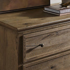 Close up of Amber Lewis x Four Hands Geoffrey Tall Dresser in Worn Oak Veneer in a bedroom at Addison West