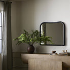 Amber Lewis x Four Hands Patz Mantel Mirror in Black Antique above a sideboard at Addison West