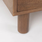 Close up of Astrid 71L x 17W x 30.3H Medium Brown Solid Wood 6 Drawer Sideboard on a white background