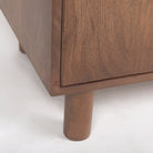 Close up of Astrid 36.0L x 17.0W x 70.0H Medium Brown Solid Wood Armoire on a white background