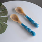 Beatriz Ball RESIN Rio Bubble Salad Servers in Blue on a wood table at Addison West