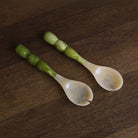 Beatriz Ball RESIN Rio Bubble Salad Servers in Green on a wood table at Addison West