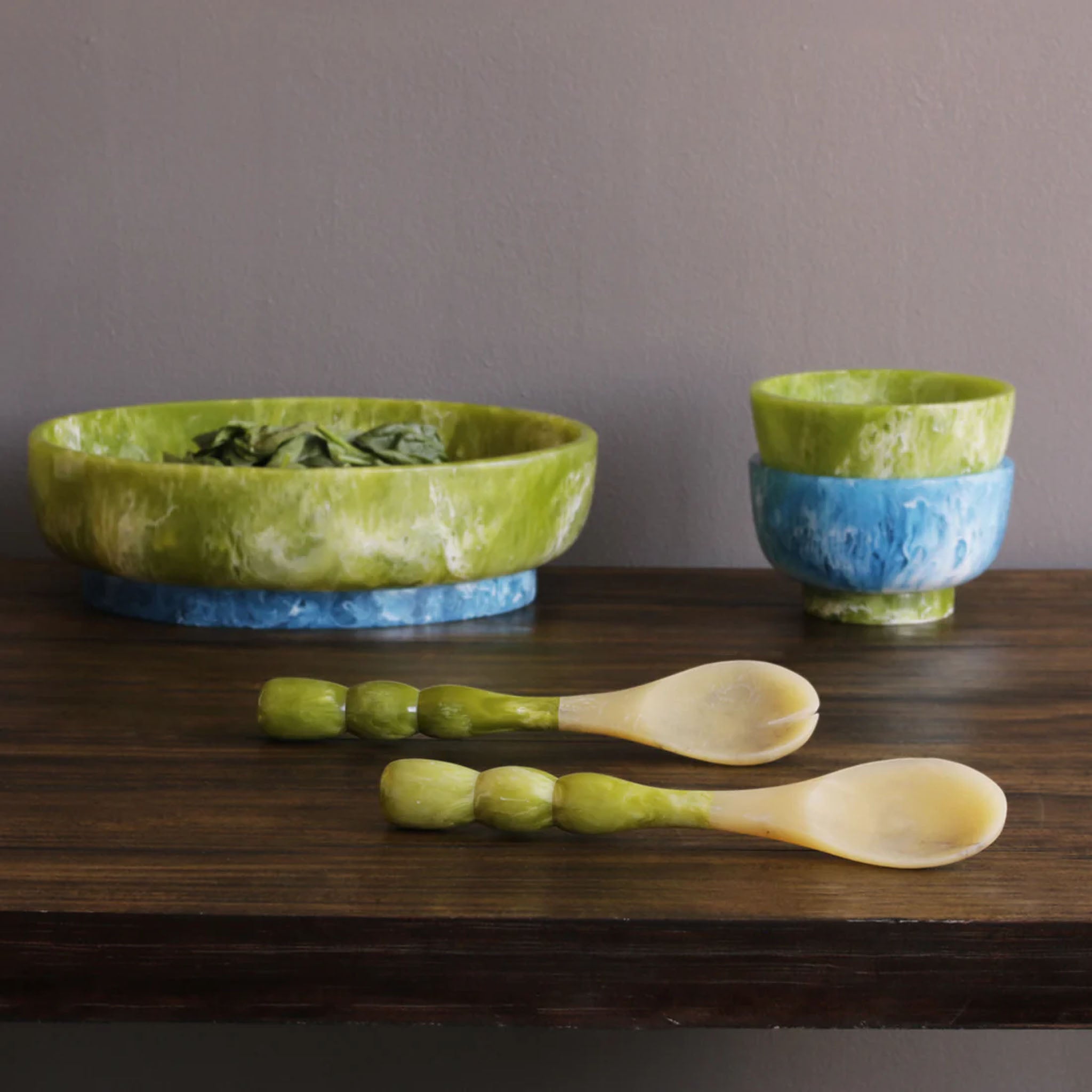 Beatriz Ball RESIN Rio Bubble Salad Servers in Green on a wood table at Addison West