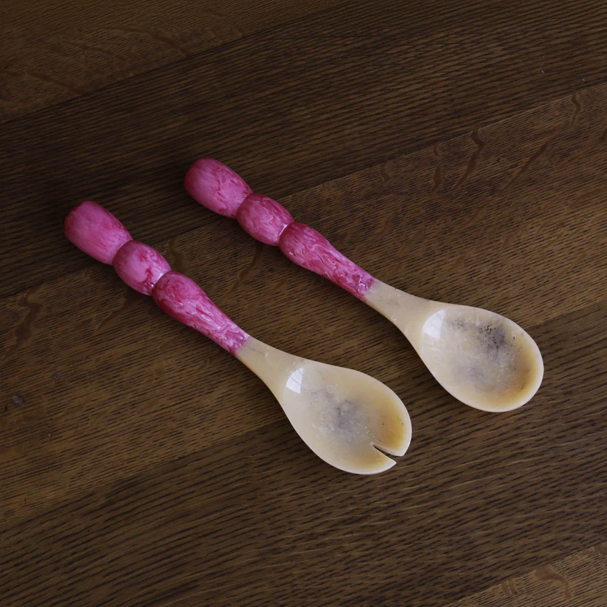 Beatriz Ball RESIN Rio Bubble Salad Servers in Pink on a wood table at Addison West