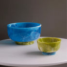 Beatriz Ball RESIN Rio Large Bowl with Base in Blue & Green on a white table at Addison West