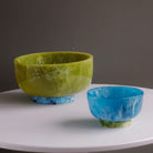 Beatriz Ball RESIN Rio Large Bowl with Base in Green & Blue on a white table at Addison West