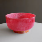 Beatriz Ball RESIN Rio Large Bowl with Base in Pink & Orange on a white table at Addison West