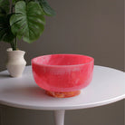 Beatriz Ball RESIN Rio Large Bowl with Base in Pink & Orange on a white table at Addison West