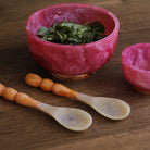 Beatriz Ball RESIN Rio Large Bowl with Base in Pink & Orange on a wood table at Addison West