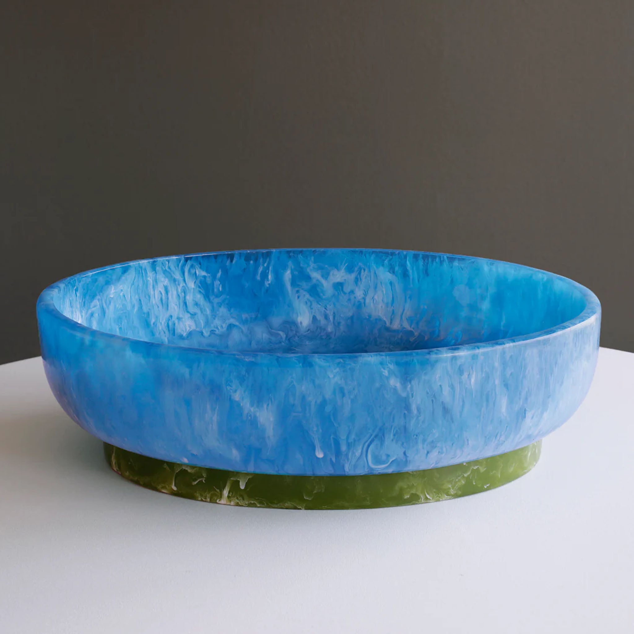 Beatriz Ball RESIN Rio Large Oval Bowl with Base in Blue & Green on a white table at Addison West