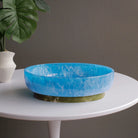 Beatriz Ball RESIN Rio Large Oval Bowl with Base in Blue & Green on a white table at Addison West