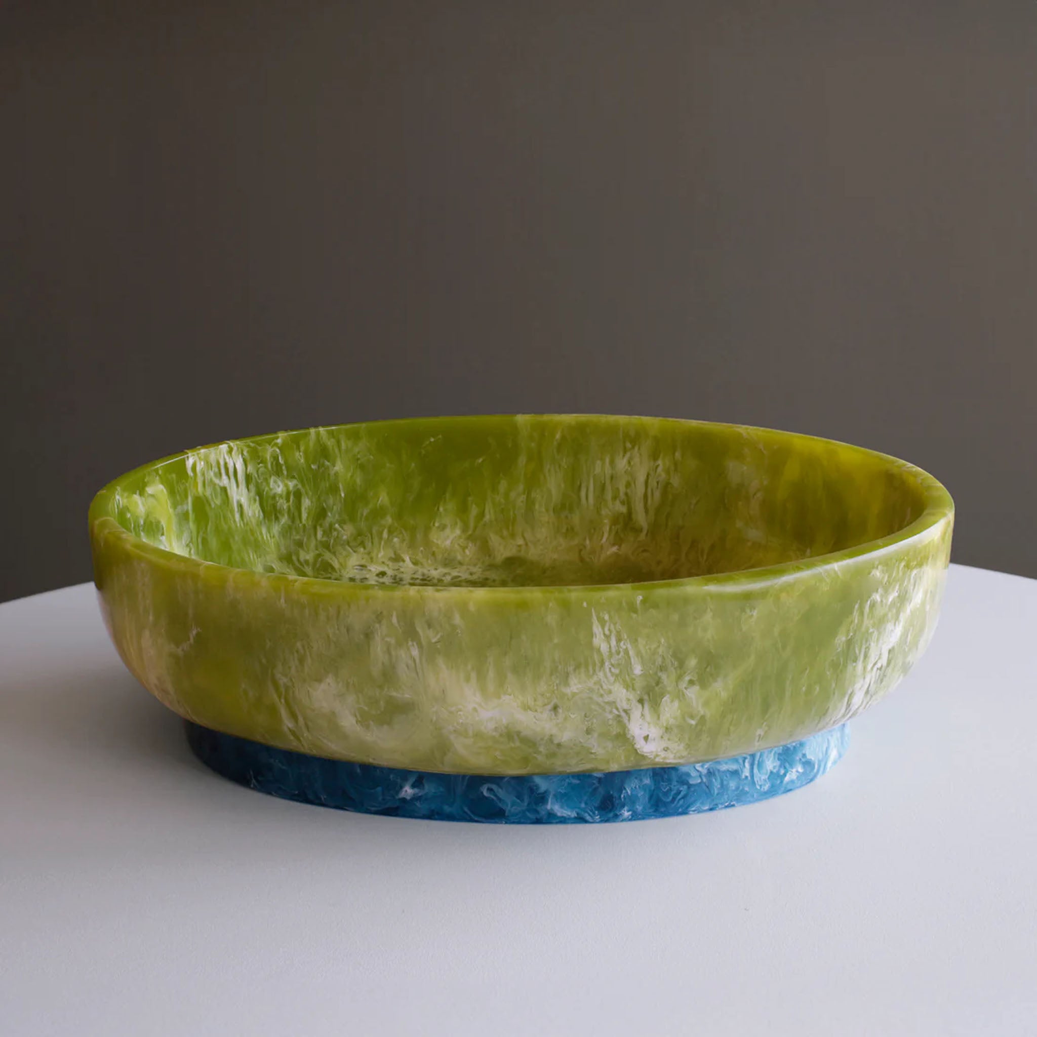 Beatriz Ball RESIN Rio Large Oval Bowl with Base in Green & Blue on a white table at Addison West