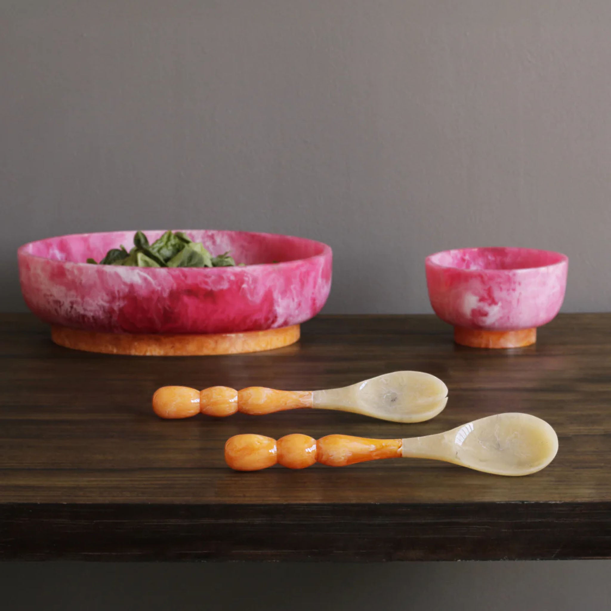 Beatriz Ball RESIN Rio Large Oval Bowl with Base in Pink & Orange on a white table at Addison West