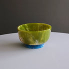 Beatriz Ball RESIN Rio Small Bowl with Base in Green & Blue on a white table at Addison West