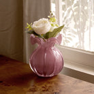 Beatriz Ball Small Vento Bud Vase in Plum on a wood table near a window at Addison West