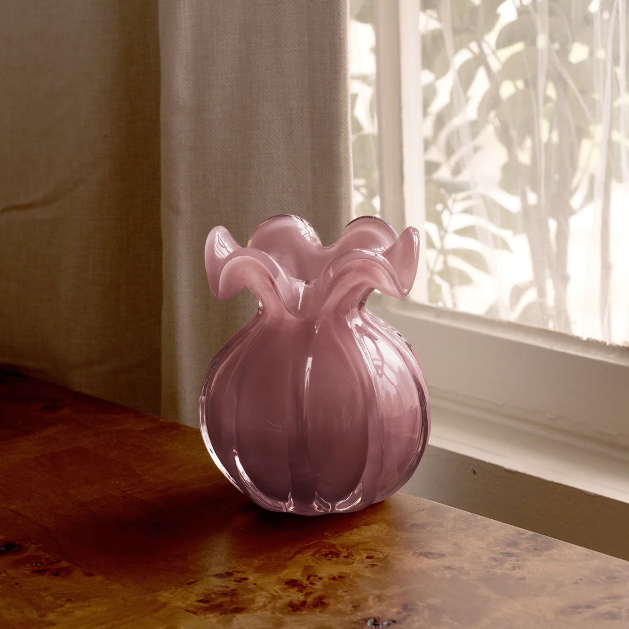 Beatriz Ball Small Vento Bud Vase in Plum on a wood table near a window at Addison West