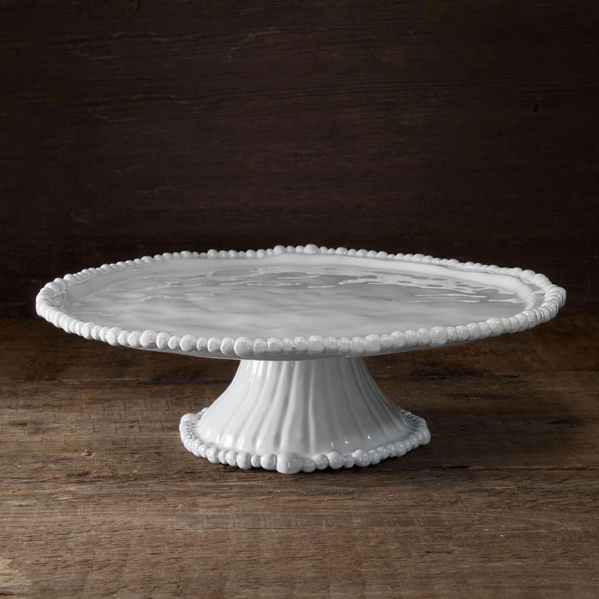 Beatriz Ball VIDA Alegria Pedestal Cake Plate on a wood table at Addison West