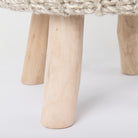 Close up of legs of the Bina Wool Stool on a white background