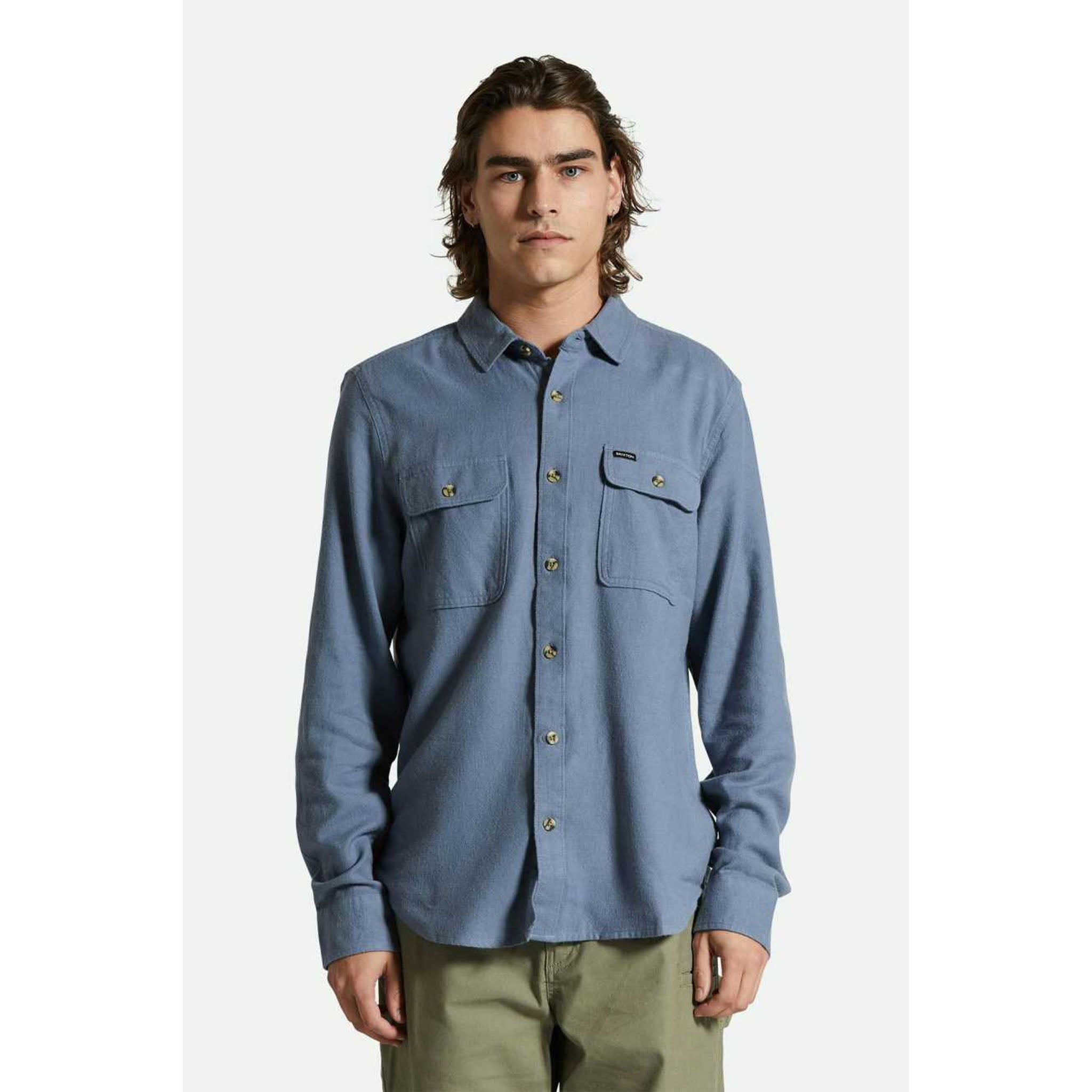 Model wearing Brixton Bowery Men's Light Weight Flannel in Flint Stone Blue in front of a white background