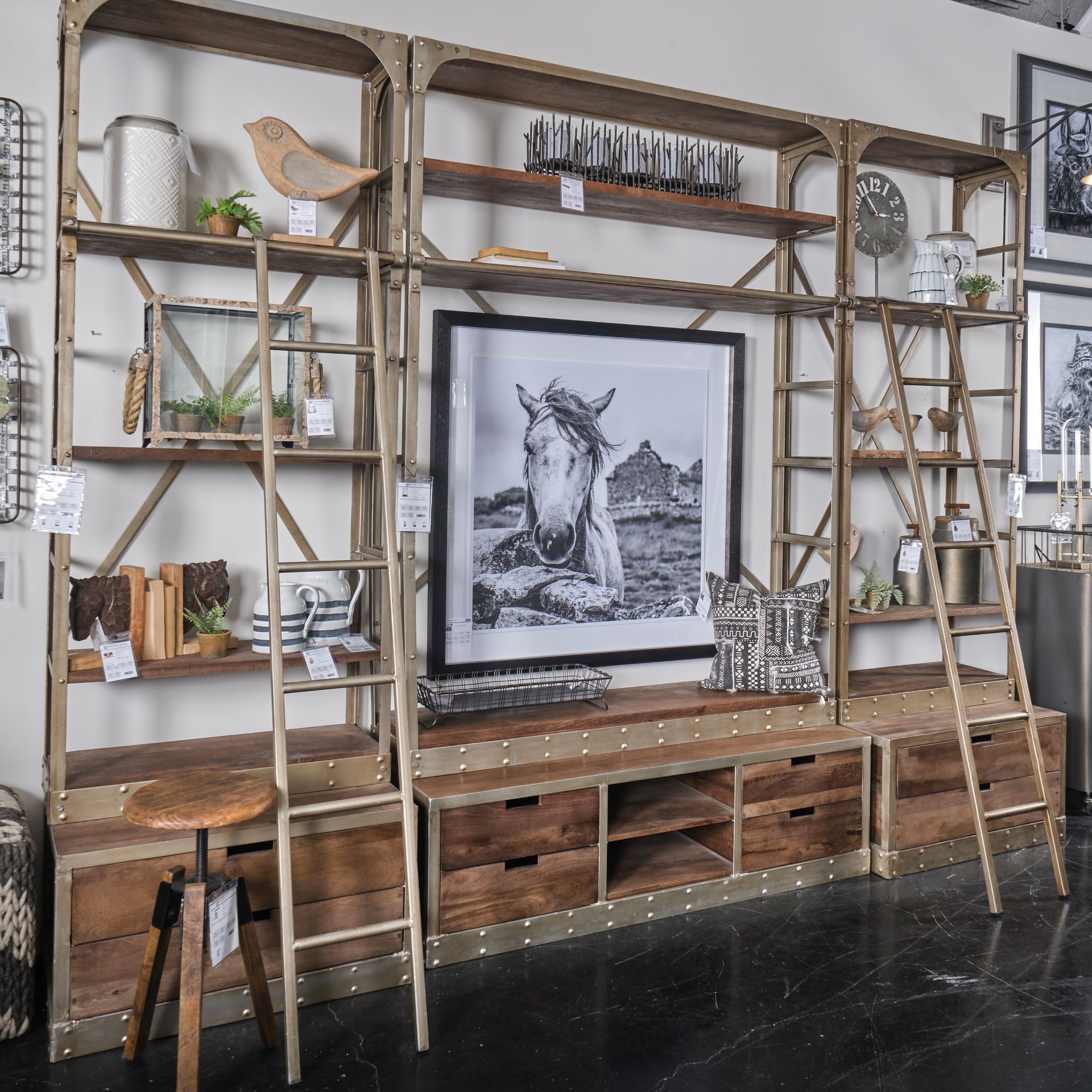 Brodie Light Brown Wood Nickle Ladder Four Shelf Shelving Unit in an industrial farmhouse living room