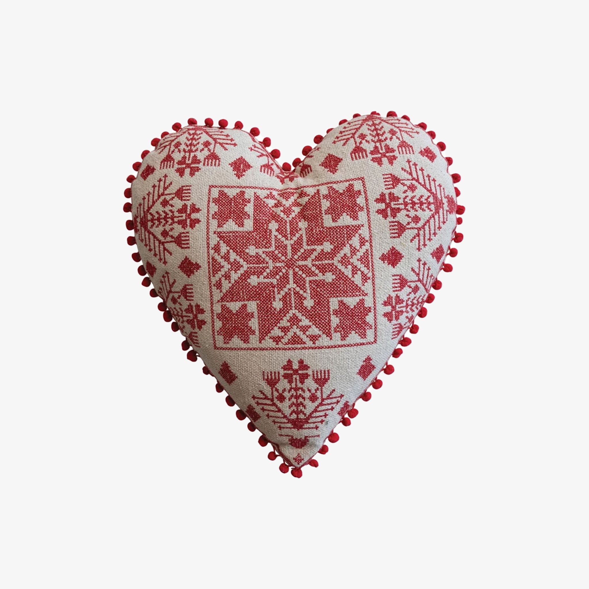 Scandinavian inspired design on a heart shaped embroidered heart shaped pillow on a white background