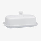 White butter dish with small white knob on top on a white backgroundWhite Porcelain Butter Dish with Knob Handle on a white background