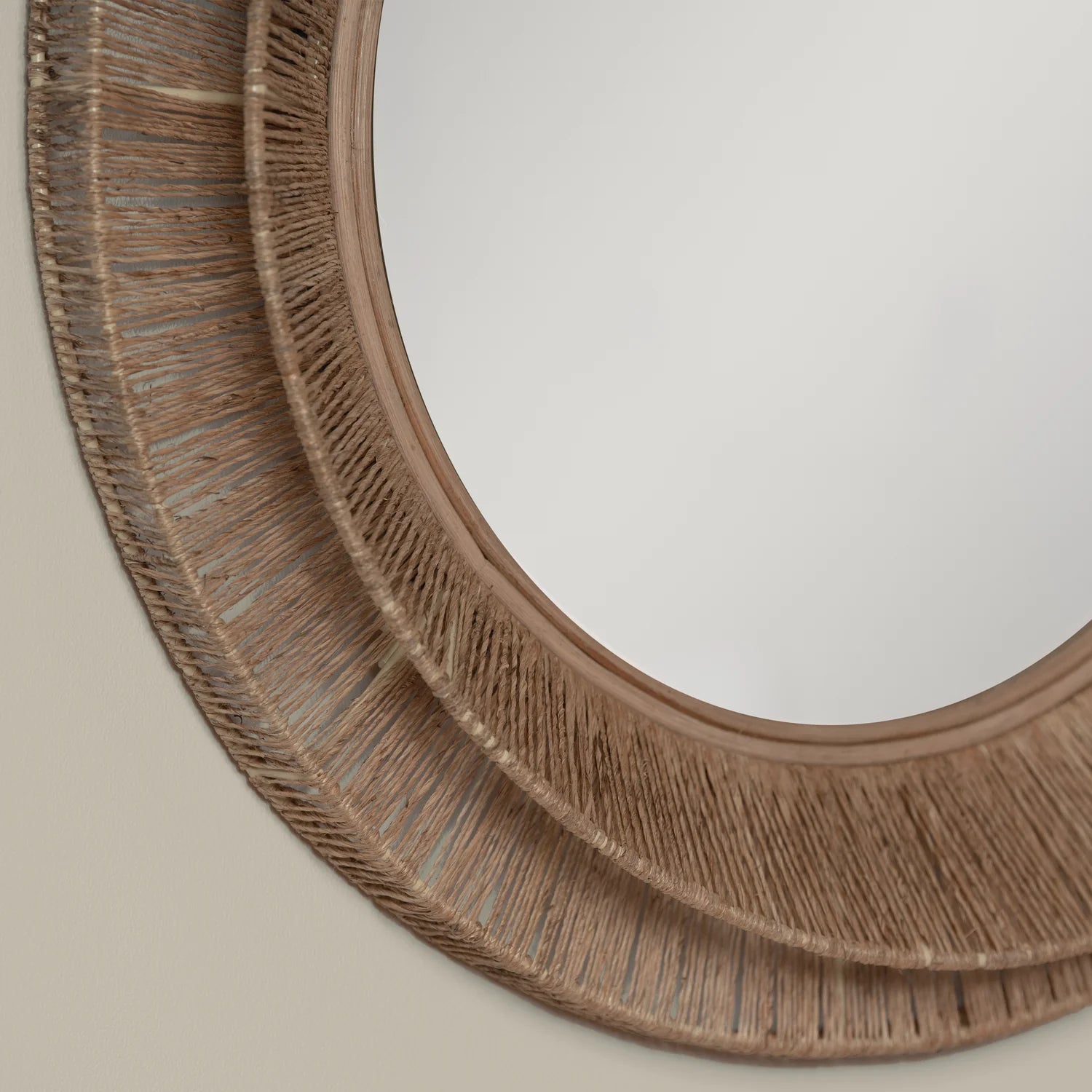 Close up of Collins Small Jute Mirror on a beige background