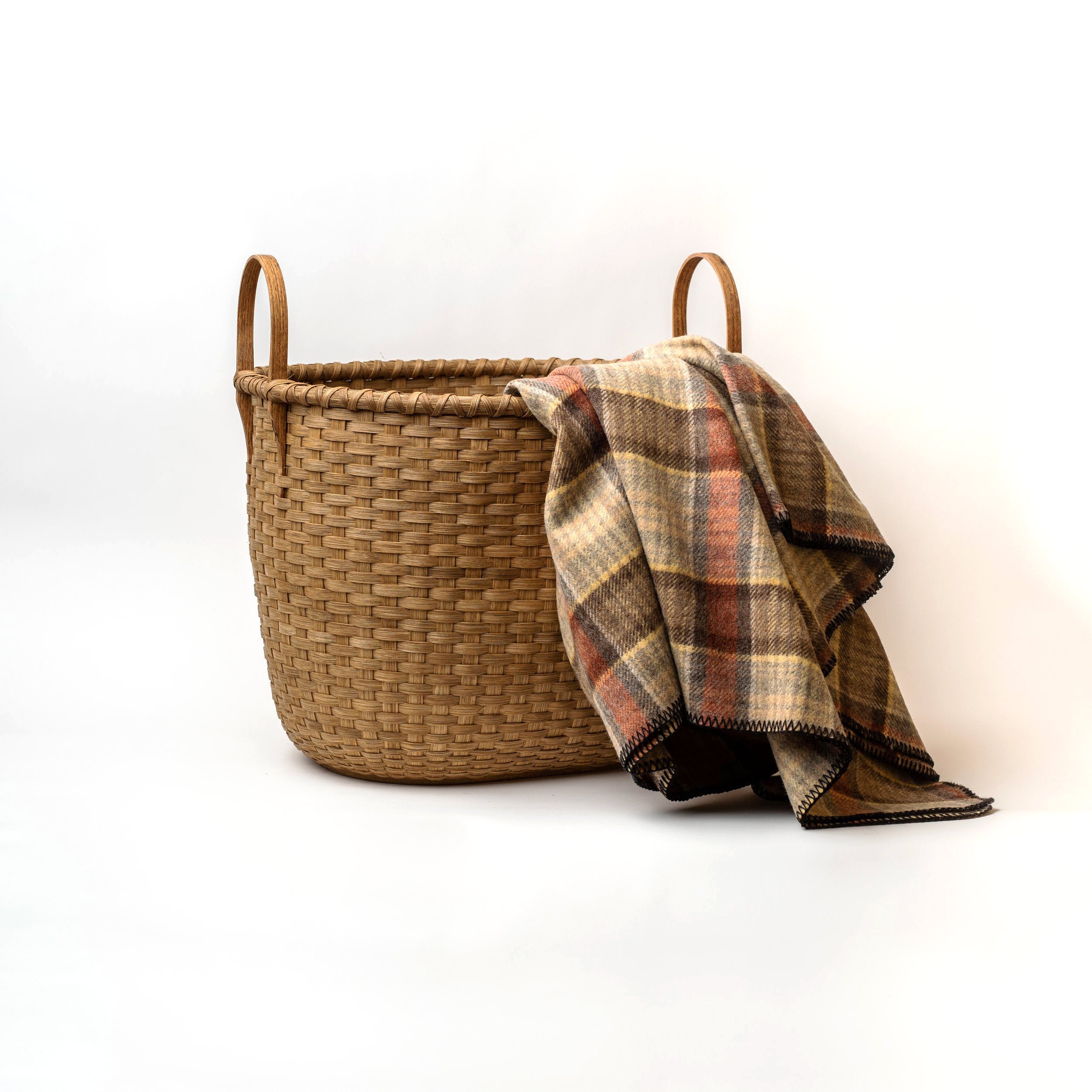 Vermont Wood Basket - Large on a white background with a blanket at Addison West