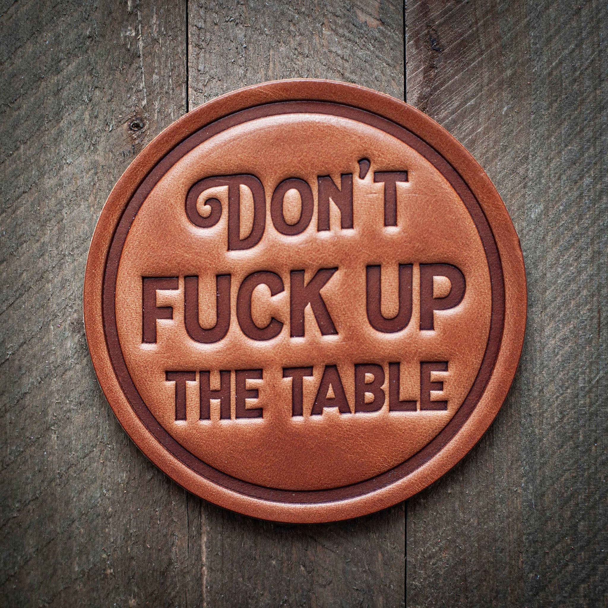 Don't F*ck up the Table Leather Coaster on a wood surface