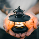 Two hands holding Edison Mini Lantern in Antique Bronze