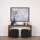 Estelle Rustic Brown Reclaimed Wood Console Table in a hallway above two ottomans