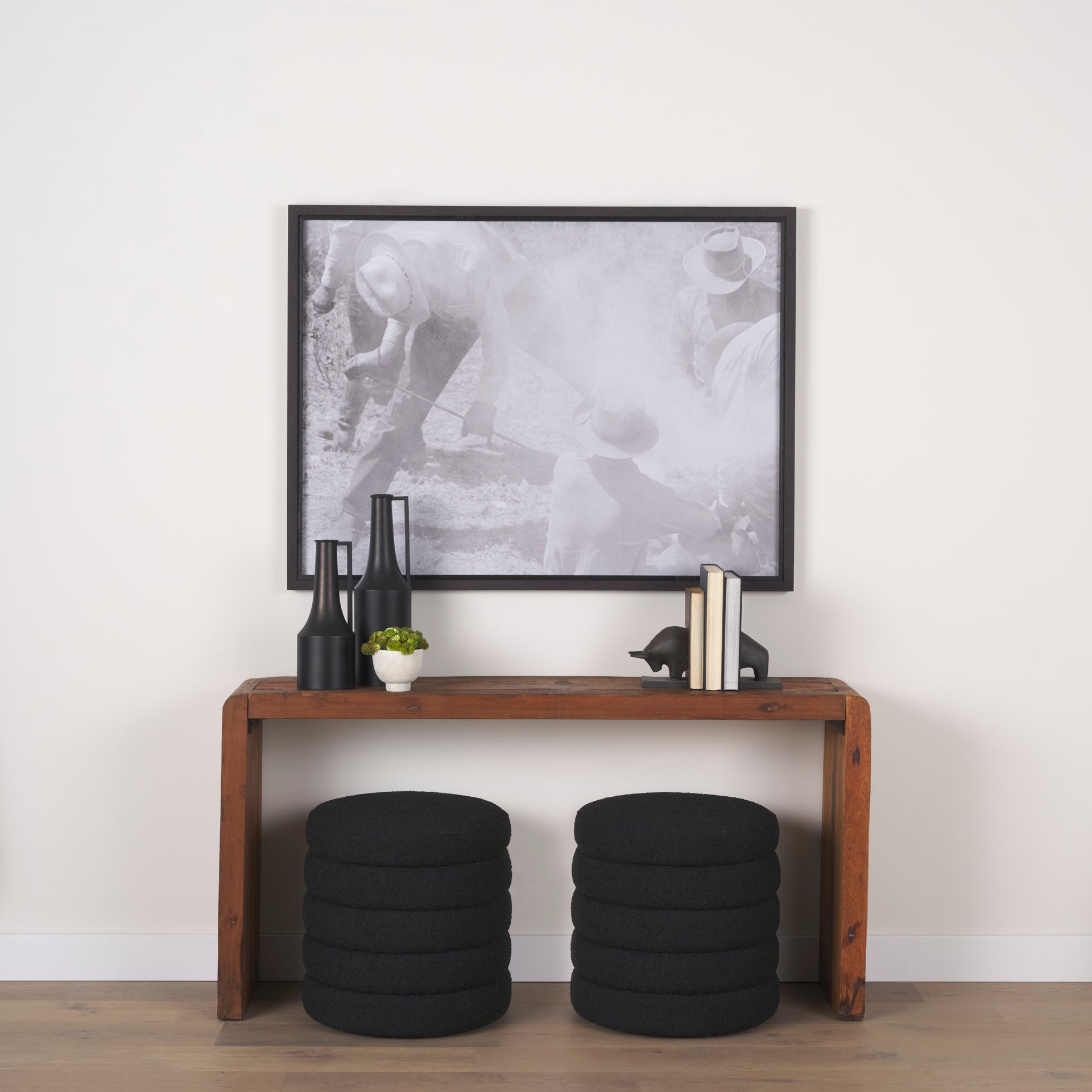 Estelle Rustic Brown Reclaimed Wood Console Table in a hallway above two ottomans