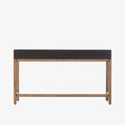 Four Hands Fiona Desk in Black Raffia with brass legs on a white background