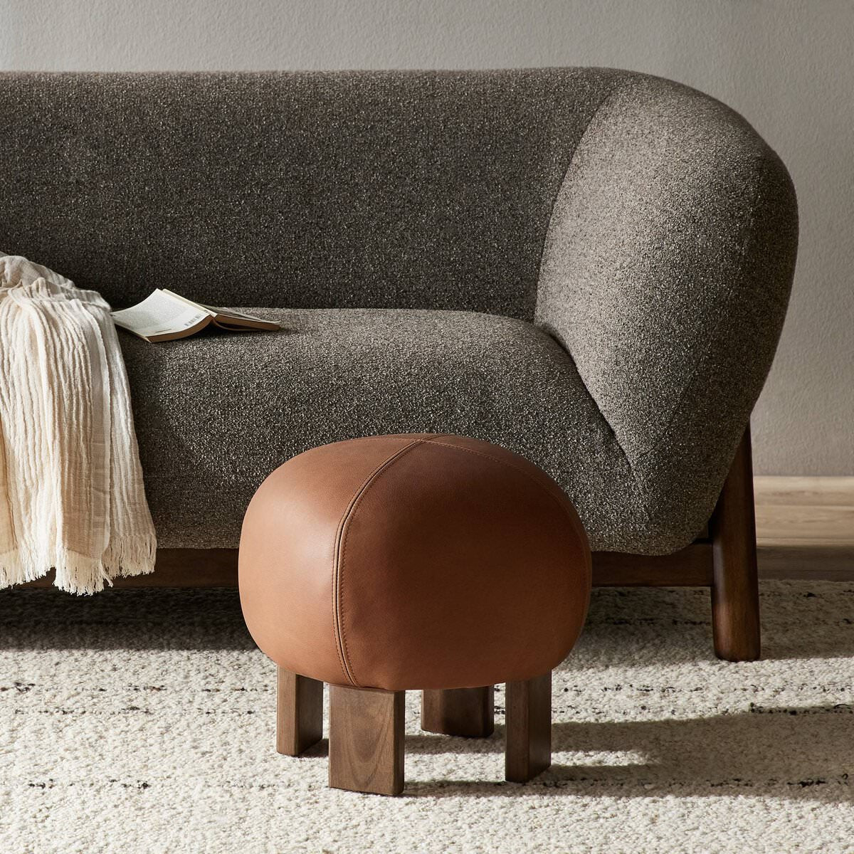 Four Hands Alma Ottoman in Brickhouse Cognac in a modern living room