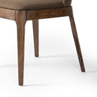 Close up of legs of Four Hands Bryce Armless Dining Chair in Bilton Olive on a white background