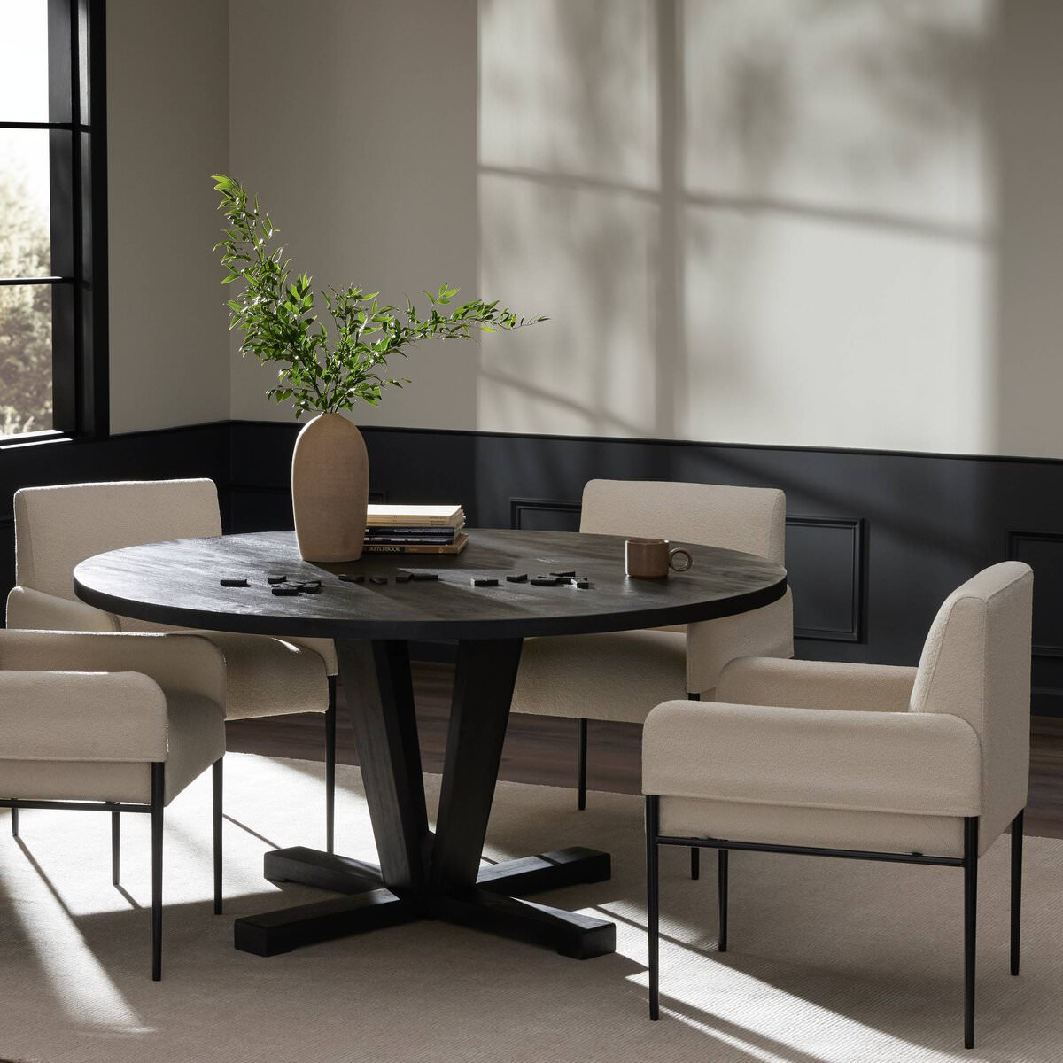 Four Hands black Cobain Dining Table 60" seats 8 in a modern living room