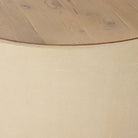 Close up of Four Hands Crosby Round Coffee Table in Light Cream on a white background