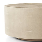 Close up of Four Hands Crosby Round Coffee Table in Light Cream on a white background