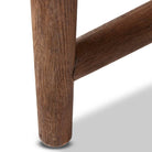 Close up of leg of  Four Hands Glenview Desk in Weathered Oak Veneer on a white background