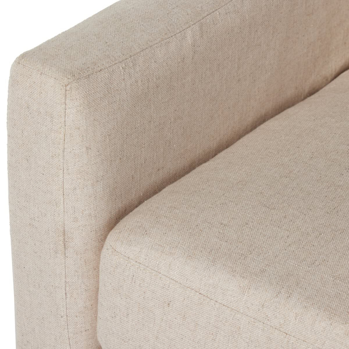 Close up of Four Hands Hampton Slipcover Swivel Chair in Evere Creme on a white background