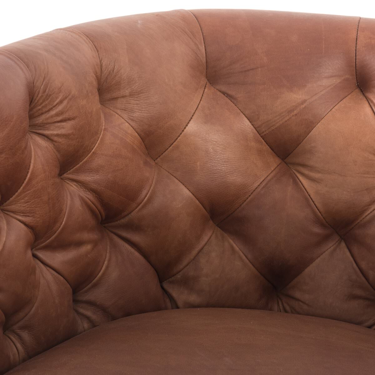 Close up of Four Hands Hanover Swivel Chair in Heirloom Sienna on a white background