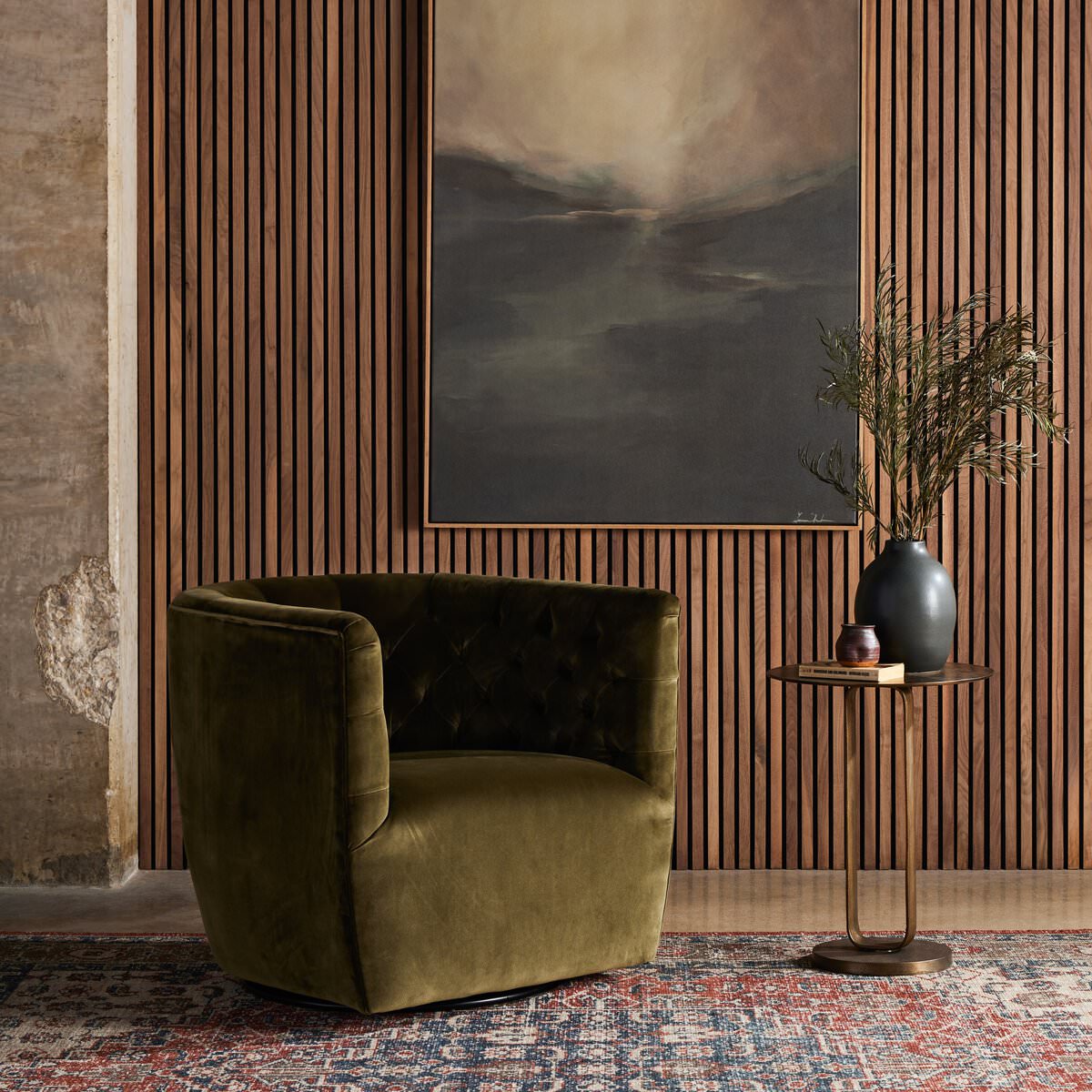 Four Hands Hanover Swivel Chair in Surrey Olive against a wood wall