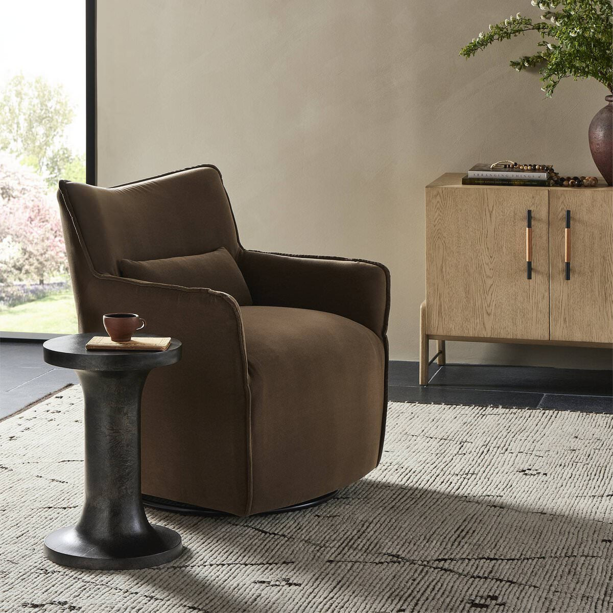 Four Hands Kimble Swivel Chair in Henry Coffee in a modern neutral living room