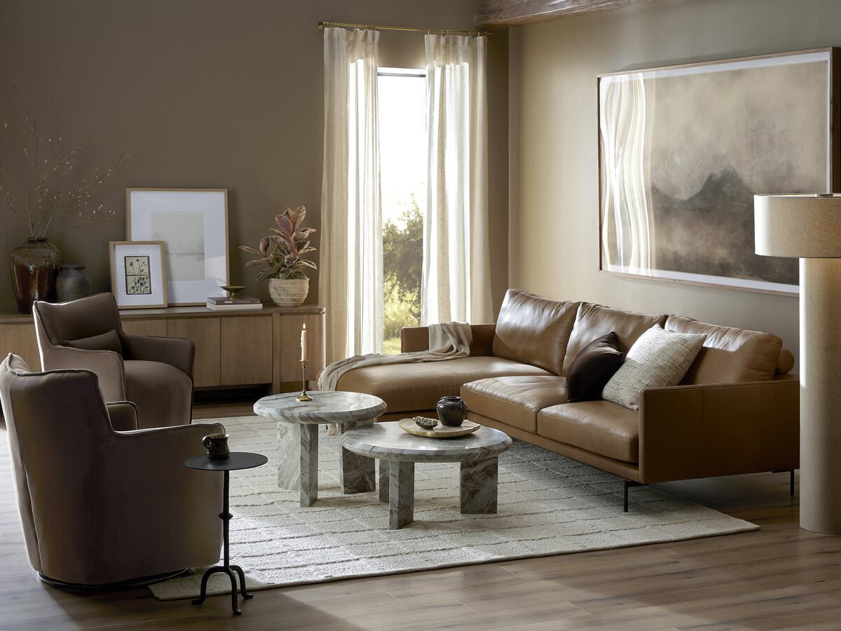 Four Hands Kimble Swivel Chair in Henry Coffee in a modern neutral living room