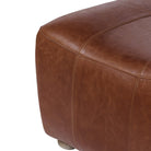 Close up of Four Hands Kylo Ottoman in Dulane Mahogany on a white background at Addison West